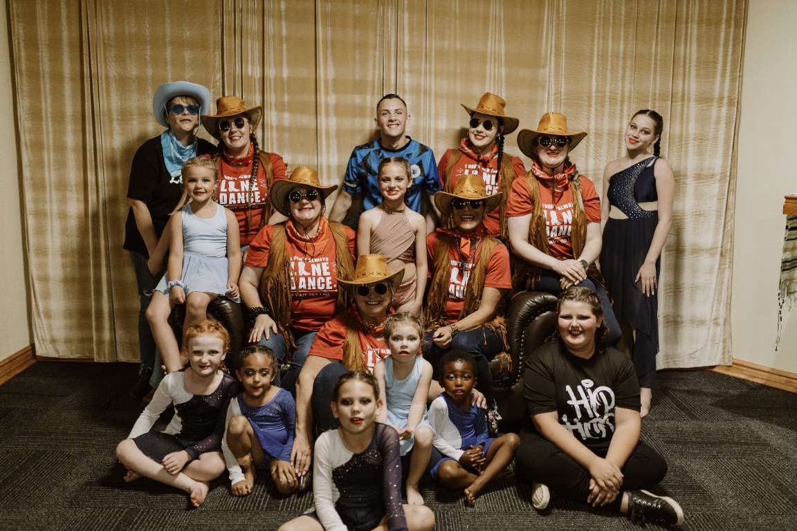 Belong dancers and coaches together after a performance