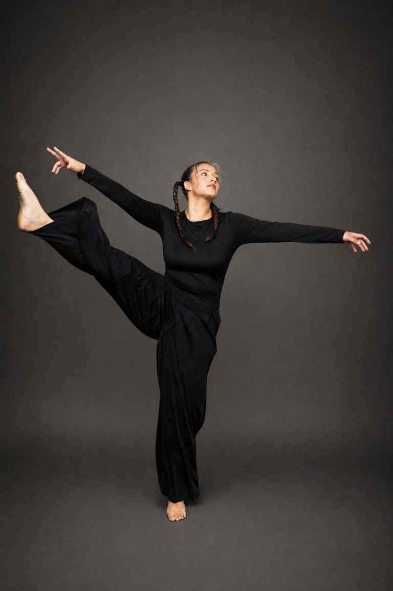 Contemporary dancer balancing with one leg raised and arms extended