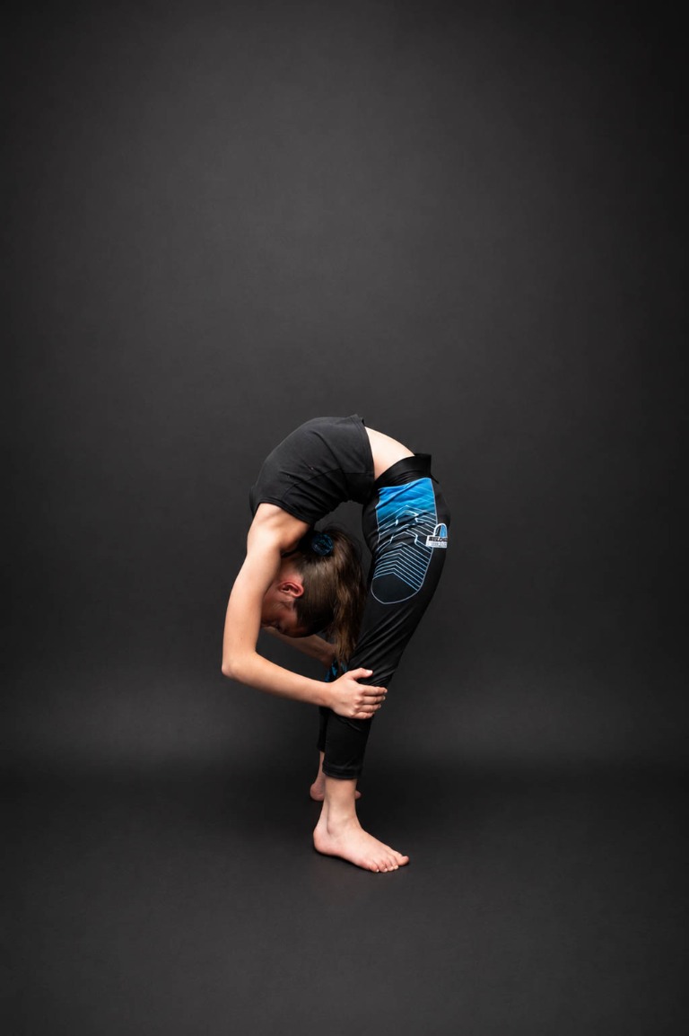 Belong acrobatics student performing a standing backbend in the studio